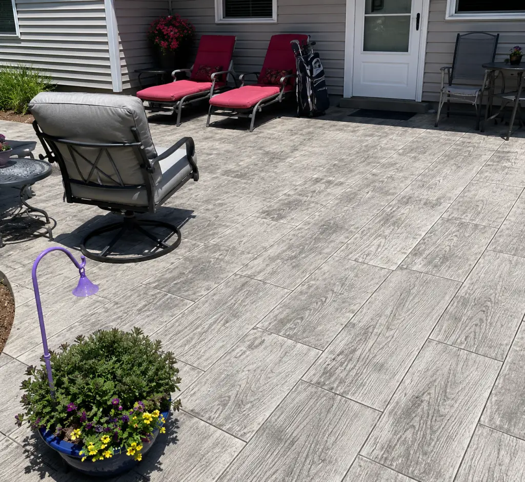 Textured Stamped Concrete Patio with Chairs and Potted Plants